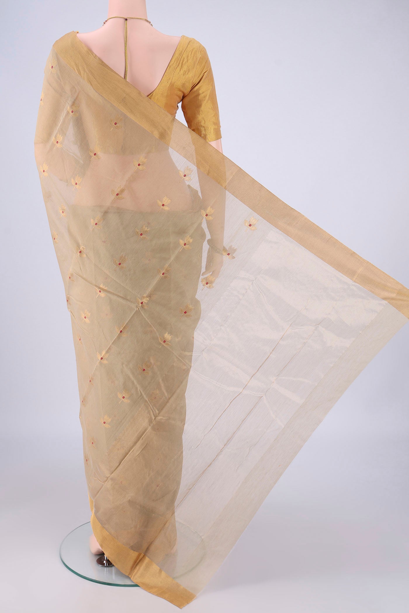 Flat view of Beige Chanderi Silk Cotton Saree with Zari And Thread Butta on the body and Zari Border. 