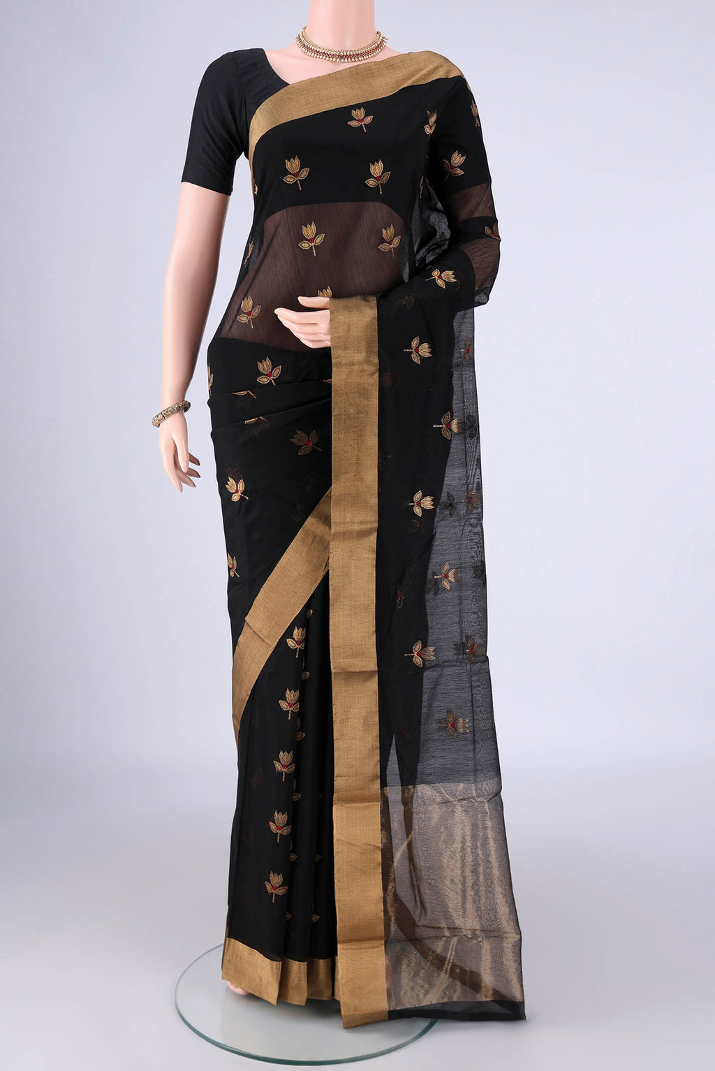 Black Silk Cotton Saree with Zari And Thread Butta on the body and Zari Border.  displayed on a mannequin