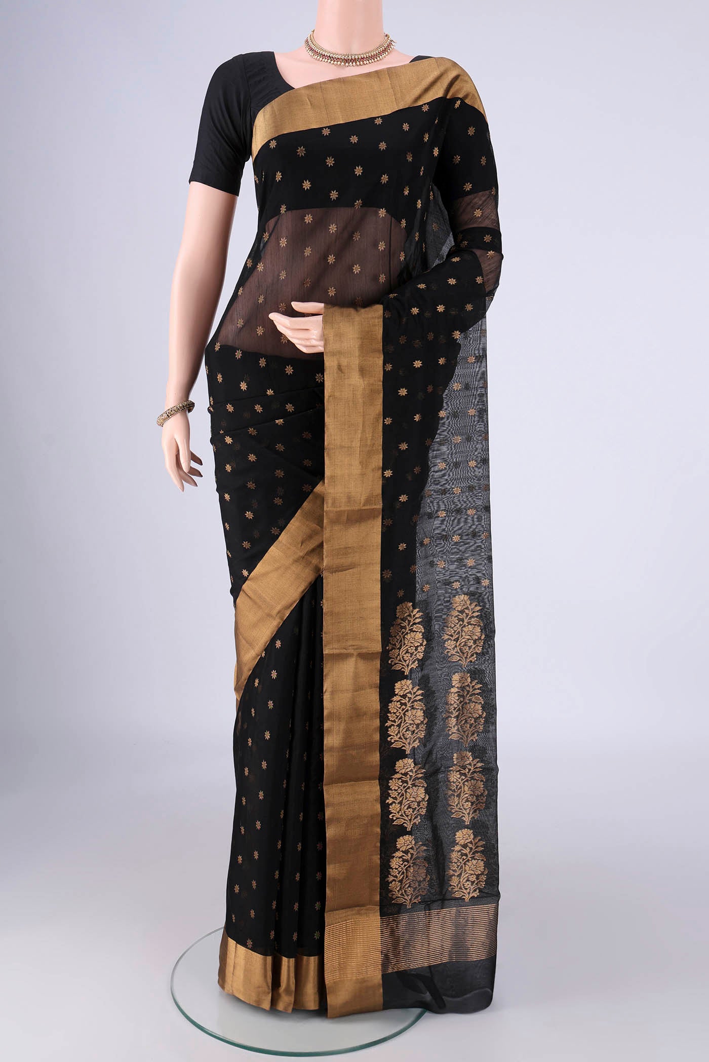 Black Chanderi Silk Cotton Saree with Zari Butta on the body and Zari Border.  displayed on a mannequin