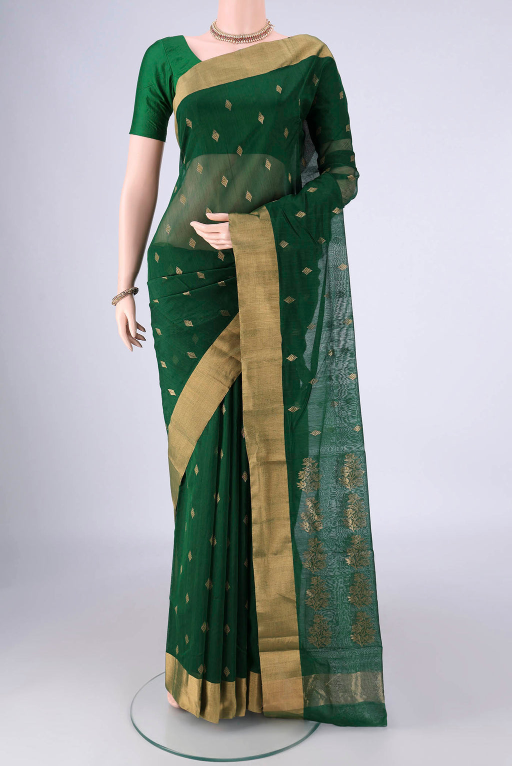 Bottle Green Chanderi Silk Cotton Saree with Zari Butta on the body and Zari Border.  displayed on a mannequin
