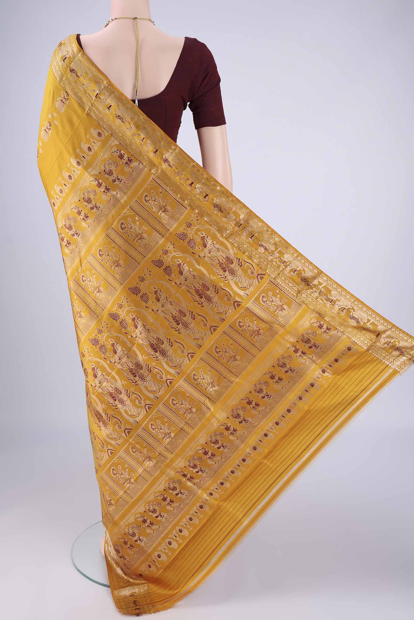 Flat view of Mustard Baluchari Silk Saree with Zari And Thread Butta on the body and Zari And Thread Border. 