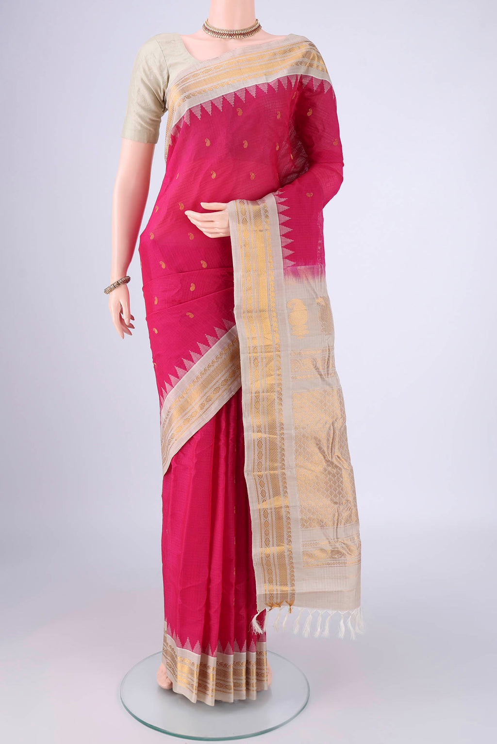 Rani Pink Gadwal Silk Cotton Saree with Zari Butta on the body and Zari Border.  displayed on a mannequin