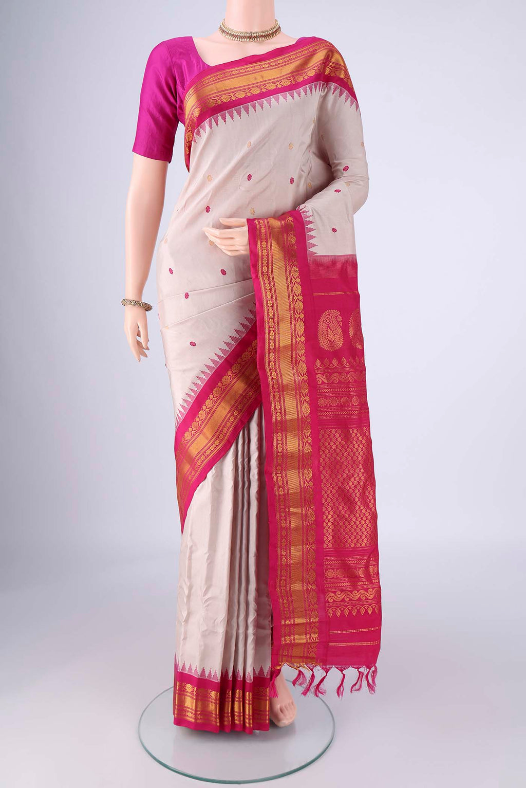 Beige Gadwal Silk Saree with Zari And Thread Butta on the body and Zari Border.  displayed on a mannequin