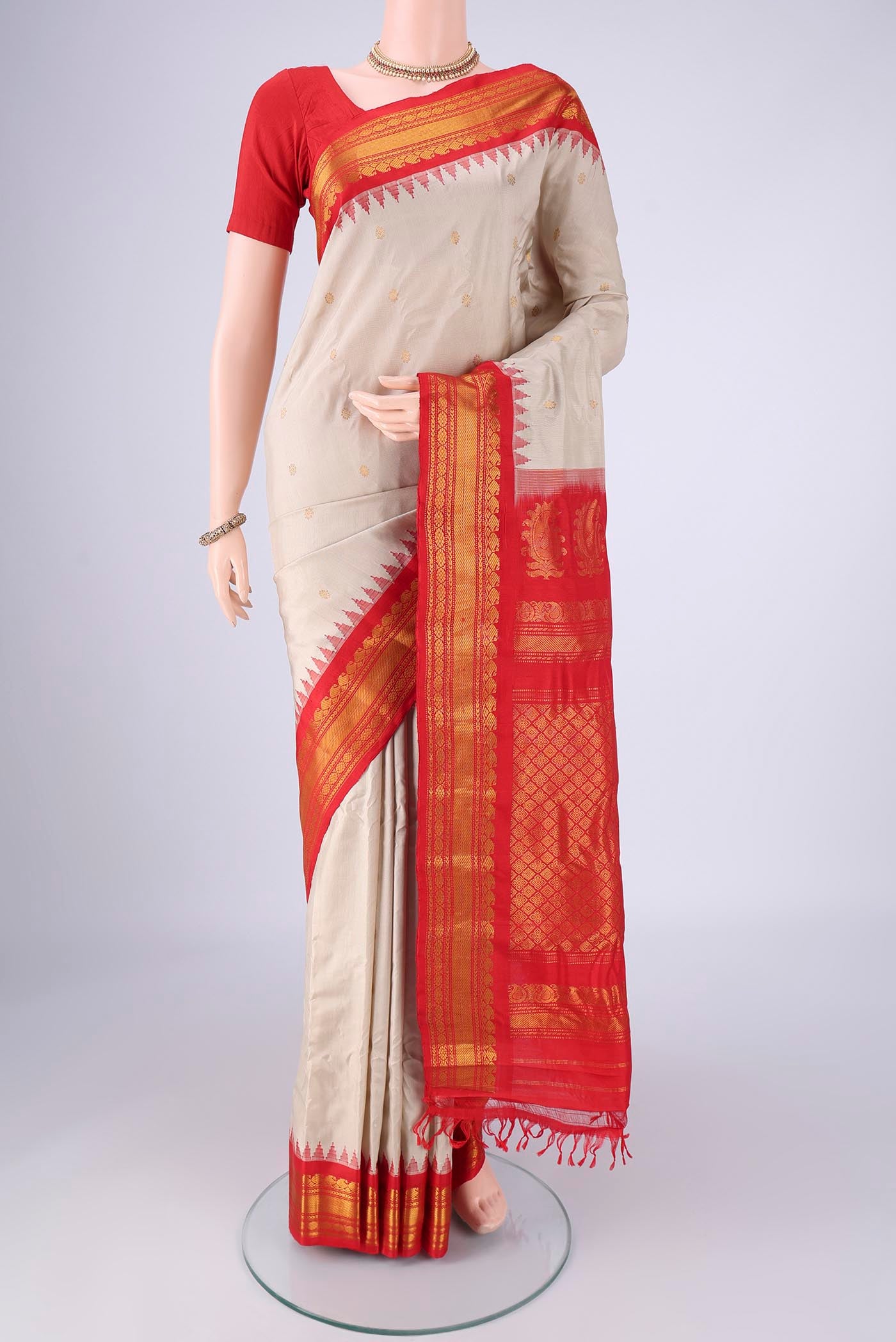 Beige Gadwal Silk Saree with Zari Butta on the body and Zari Border.  displayed on a mannequin