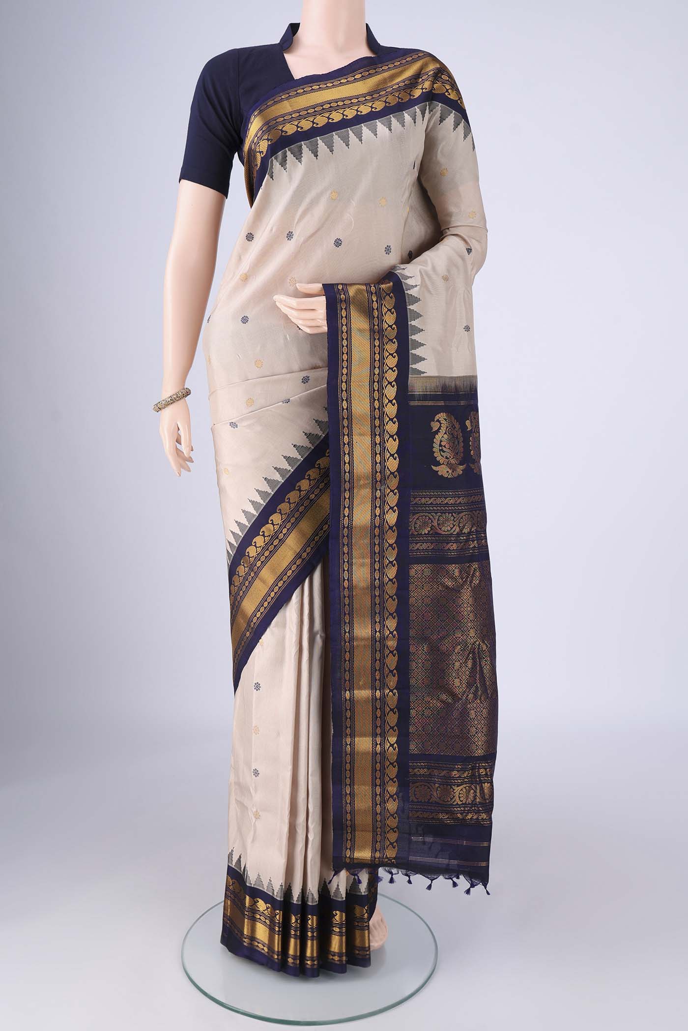 Beige Gadwal Silk Saree with Zari Butta on the body and Zari Border.  displayed on a mannequin