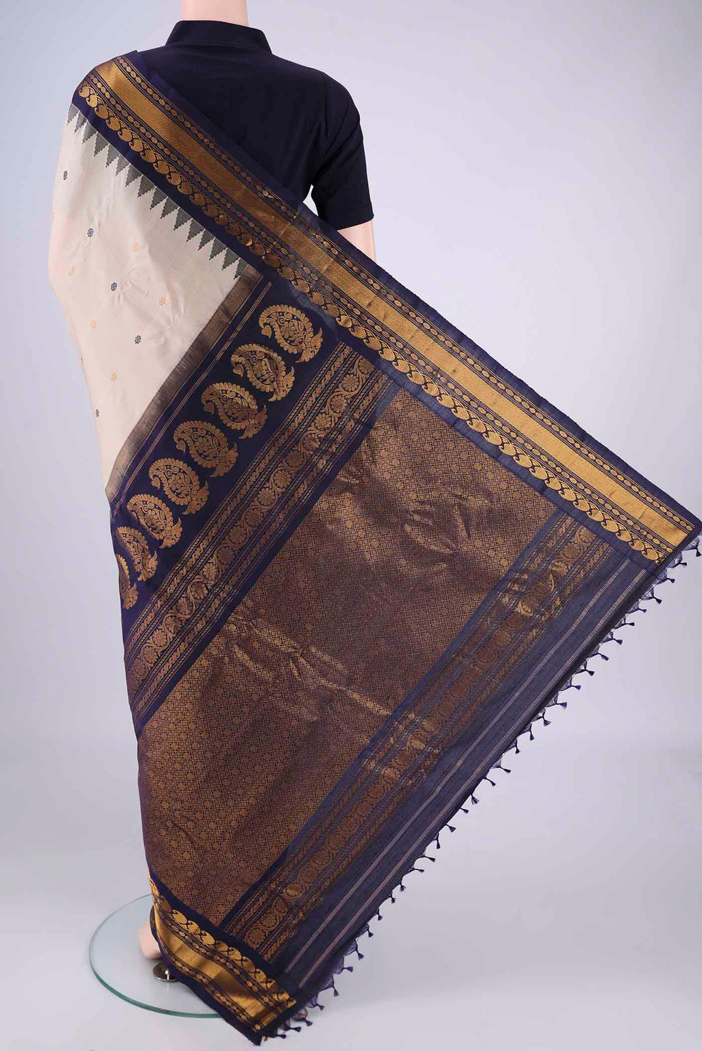 Flat view of Beige Gadwal Silk Saree with Zari Butta on the body and Zari Border. 