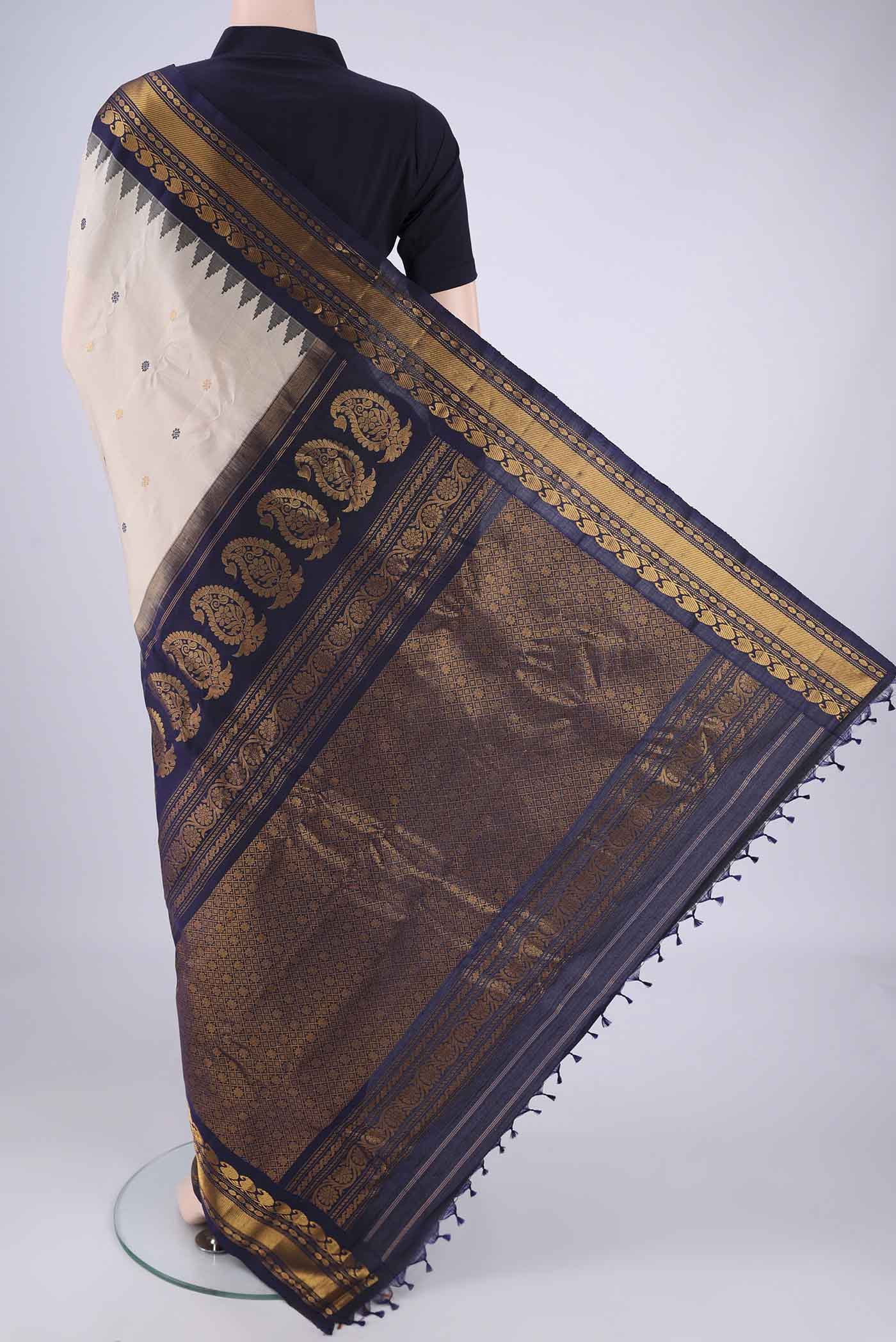 Flat view of Beige Gadwal Silk Saree with Zari Butta on the body and Zari Border. 