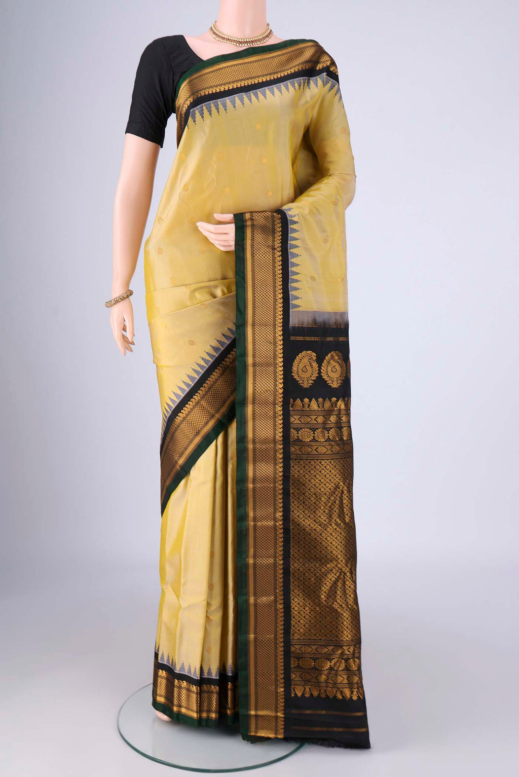 Lemon Yellow Gadwal Silk Saree with Zari Butta on the body and Zari Border.  displayed on a mannequin