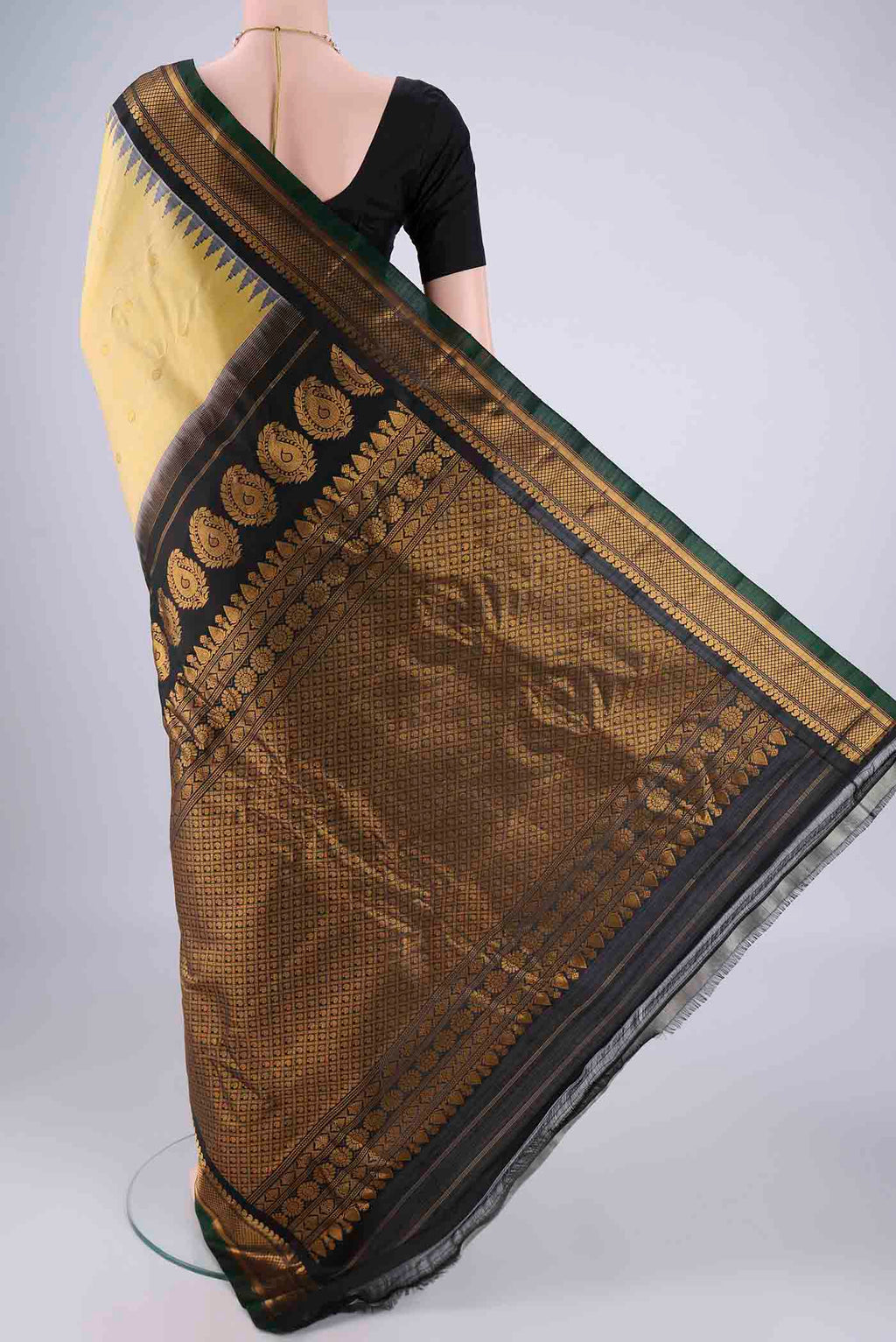 Flat view of Lemon Yellow Gadwal Silk Saree with Zari Butta on the body and Zari Border. 