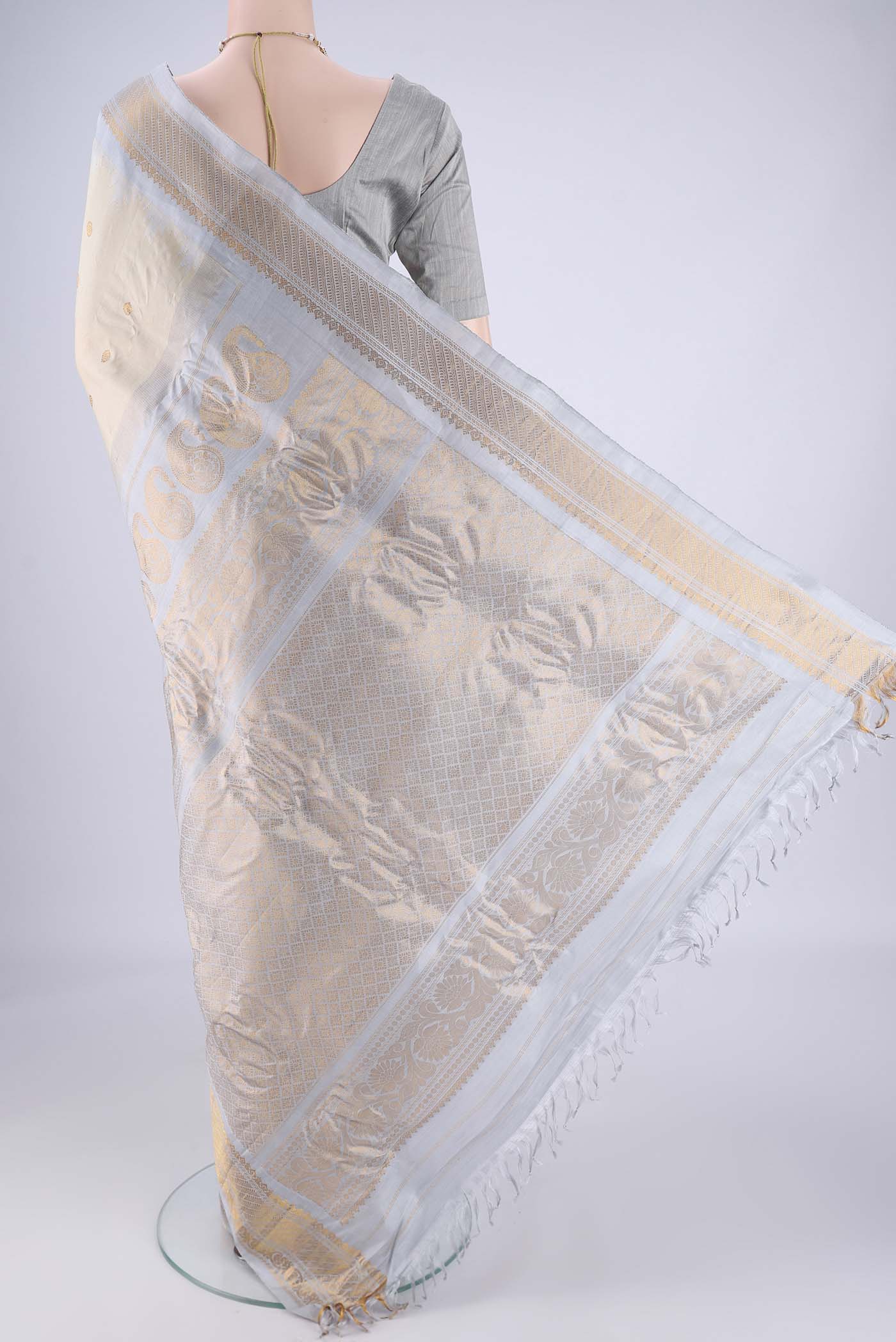Flat view of Beige Gadwal Silk Saree with Zari Butta on the body and Zari Border. 