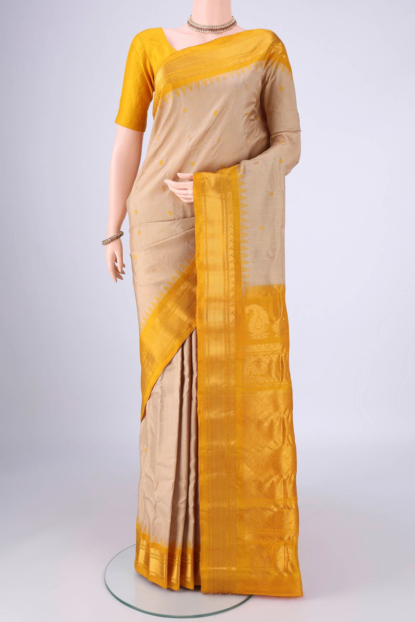 Beige Gadwal Silk Saree with Checked design on the body and Zari Border.  displayed on a mannequin