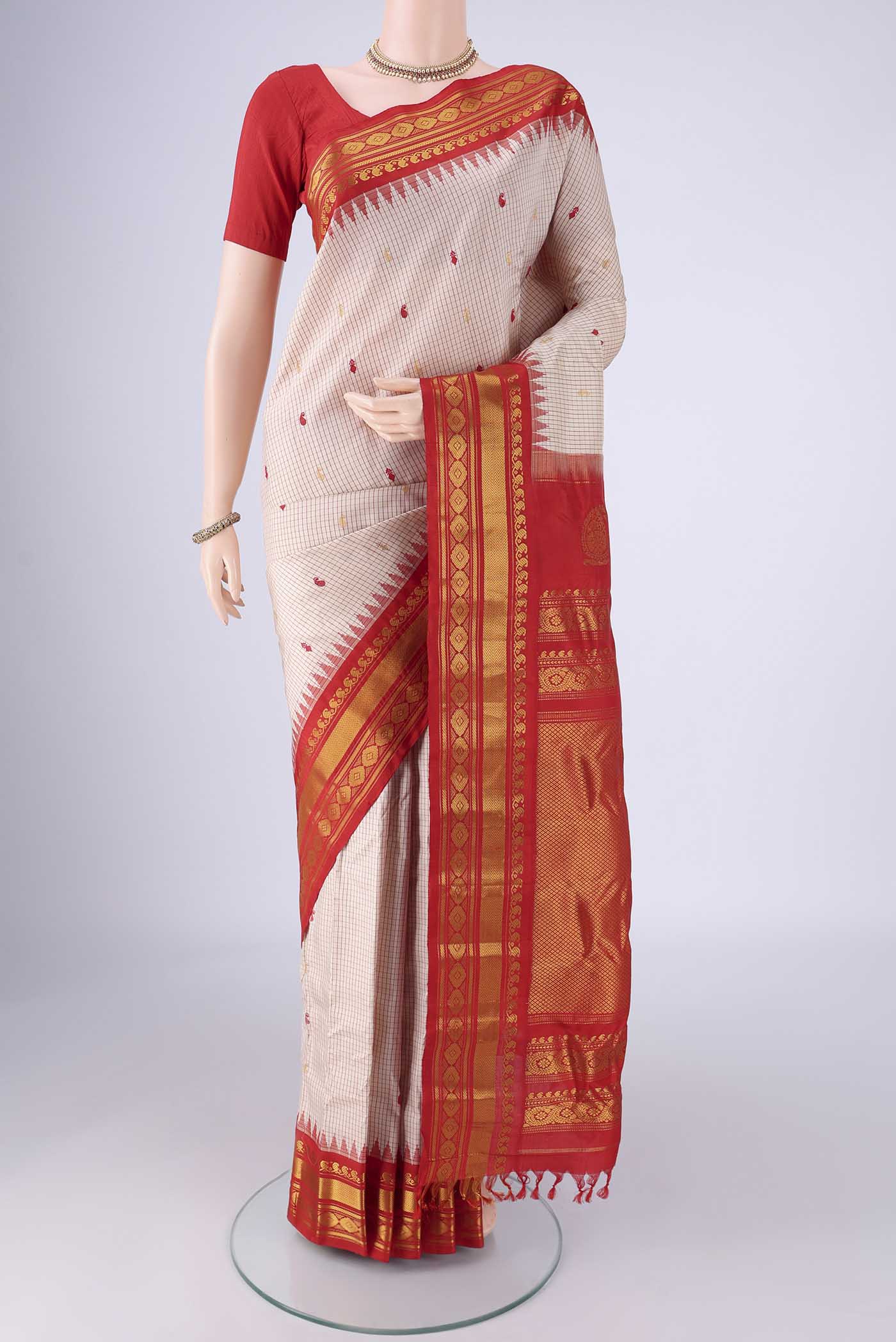 Beige Gadwal Silk Saree with Checked design on the body and Silk Border.  displayed on a mannequin