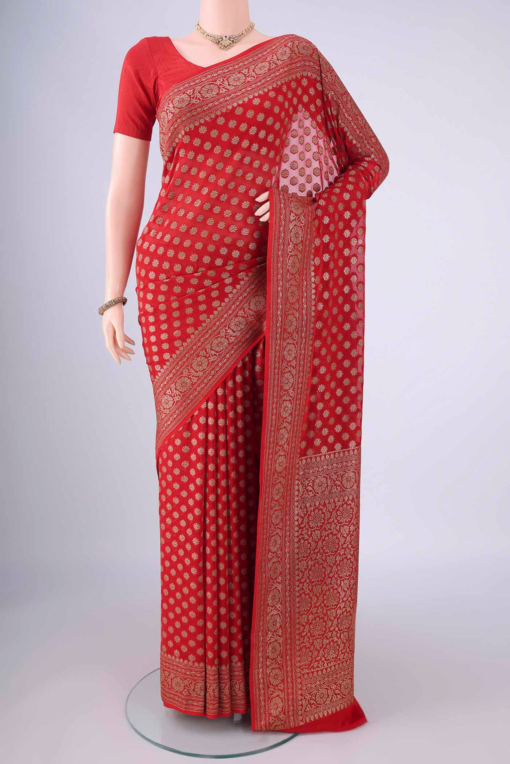 Red Banarasi Georgette Saree with Zari Butta on the body and Zari Border.  displayed on a mannequin