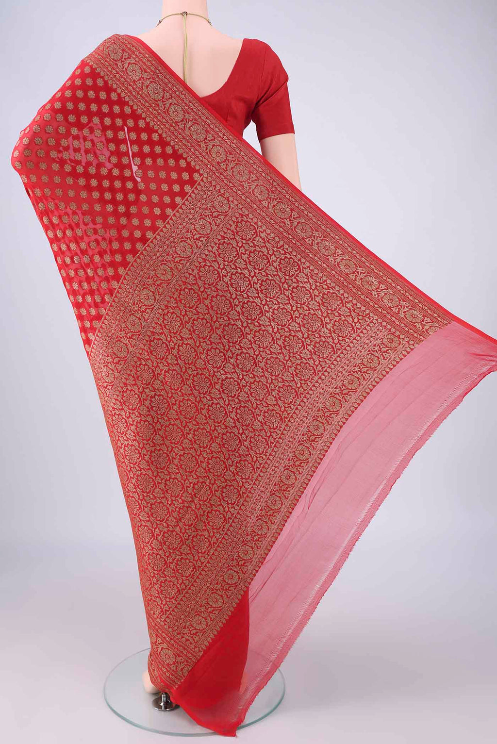 Flat view of Red Banarasi Georgette Saree with Zari Butta on the body and Zari Border. 