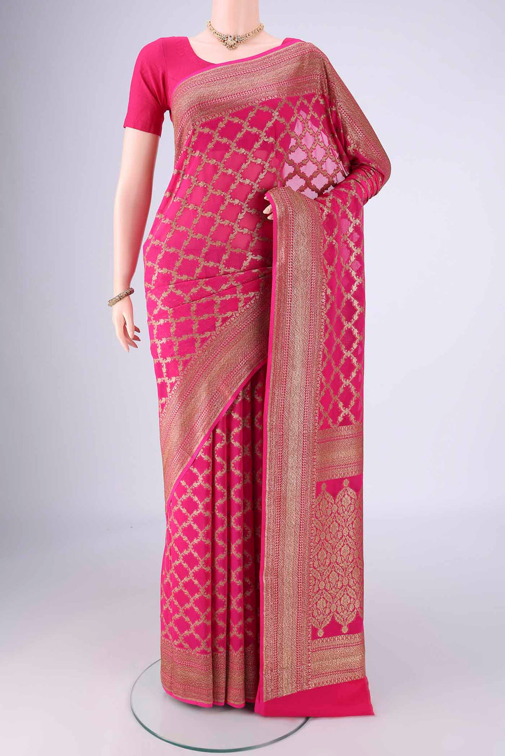 Rani Pink Banarasi Georgette Saree with Zari Brocade on the body and Zari Border.  displayed on a mannequin