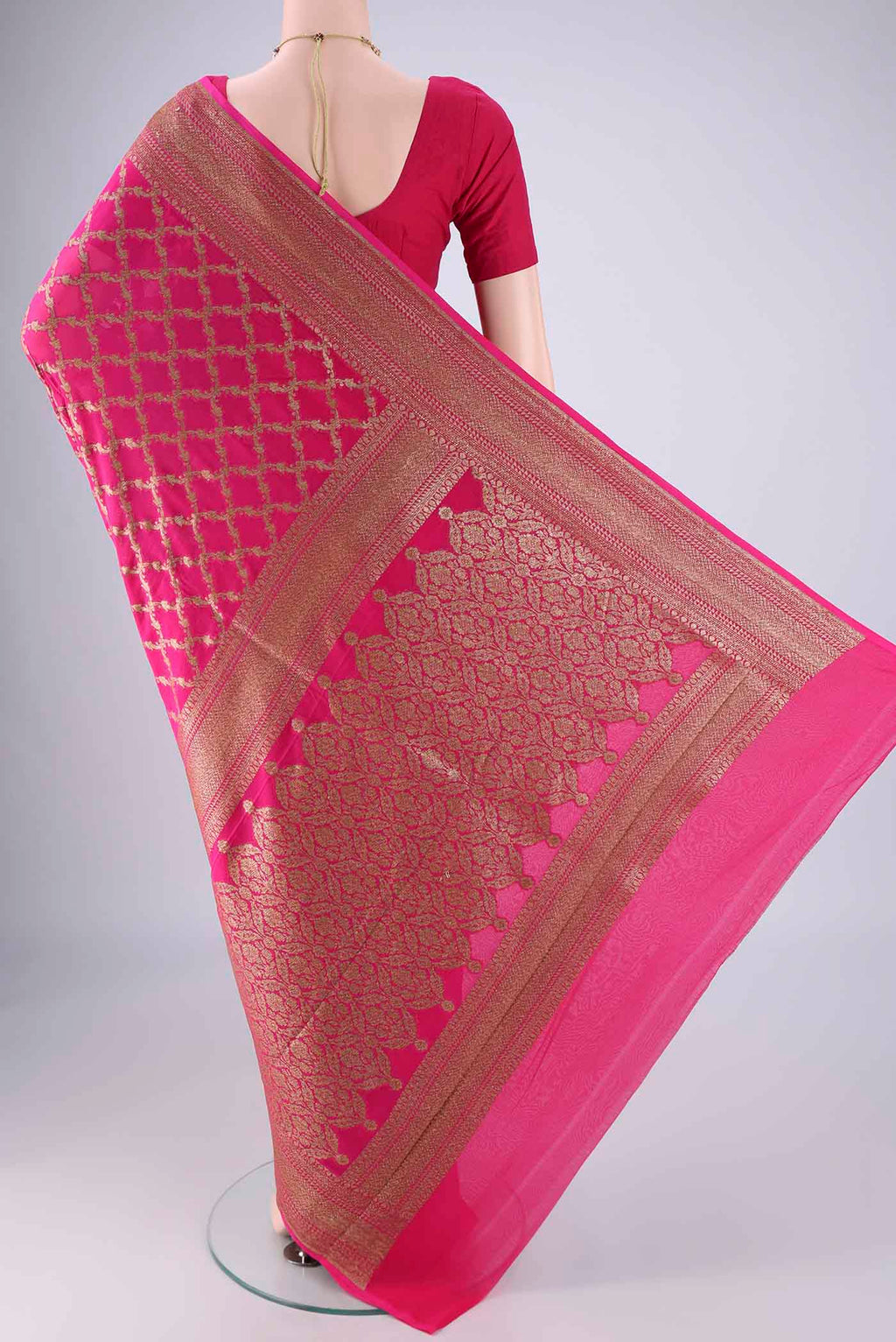Flat view of Rani Pink Banarasi Georgette Saree with Zari Brocade on the body and Zari Border. 