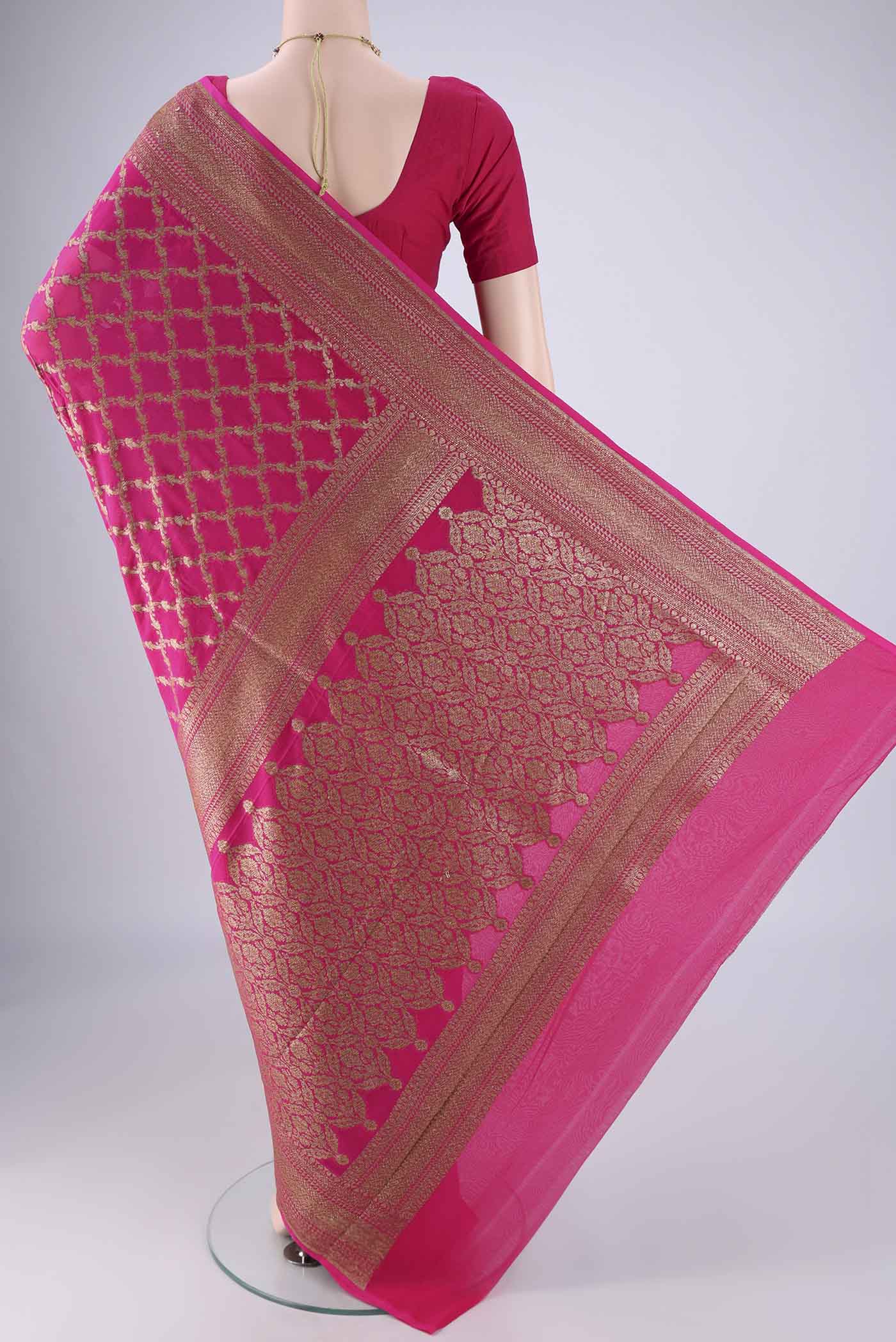 Flat view of Rani Pink Banarasi Georgette Saree with Zari Brocade on the body and Zari Border. 