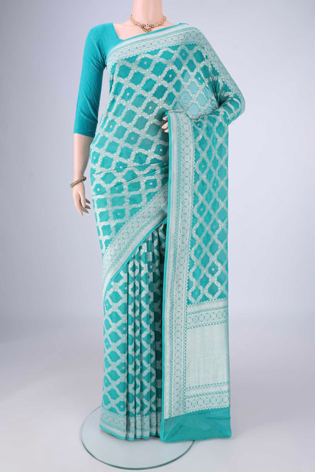 Light Blue Banarasi Georgette Saree with Zari Brocade on the body and Zari Border.  displayed on a mannequin