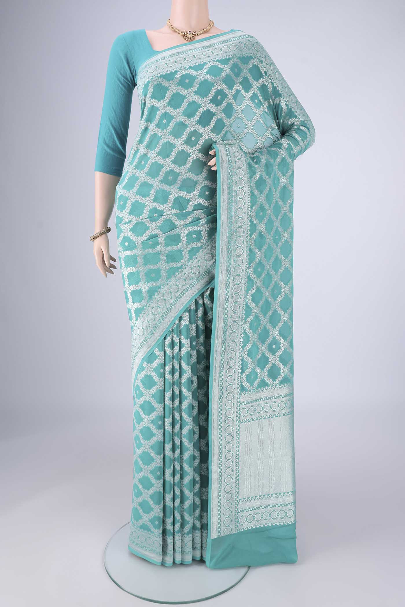 Light Blue Banarasi Georgette Saree with Zari Brocade on the body and Zari Border.  displayed on a mannequin