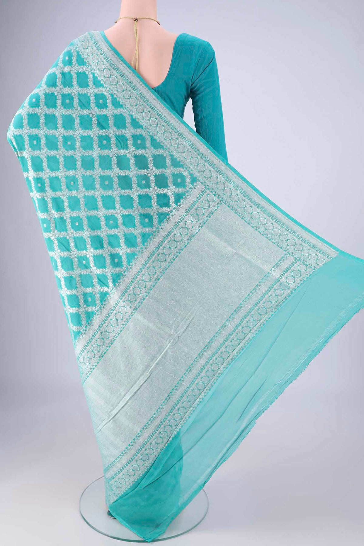Flat view of Light Blue Banarasi Georgette Saree with Zari Brocade on the body and Zari Border. 