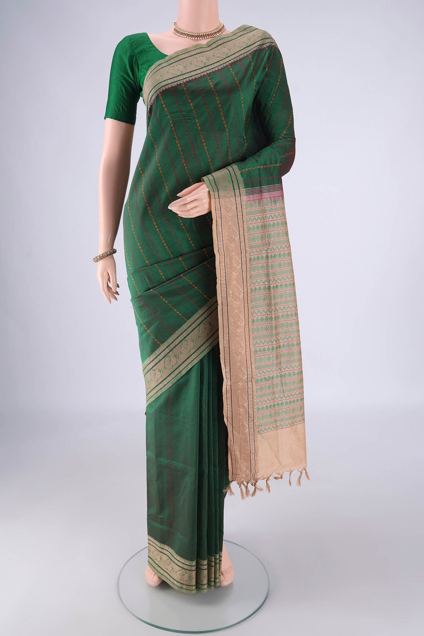 Bottle Green Blended Poly Cotton Saree with Veldhari on the body and Thread Border.  displayed on a mannequin