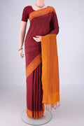 Maroon Poly Cotton Saree with Checked design on the body and Thread Border.  displayed on a mannequin