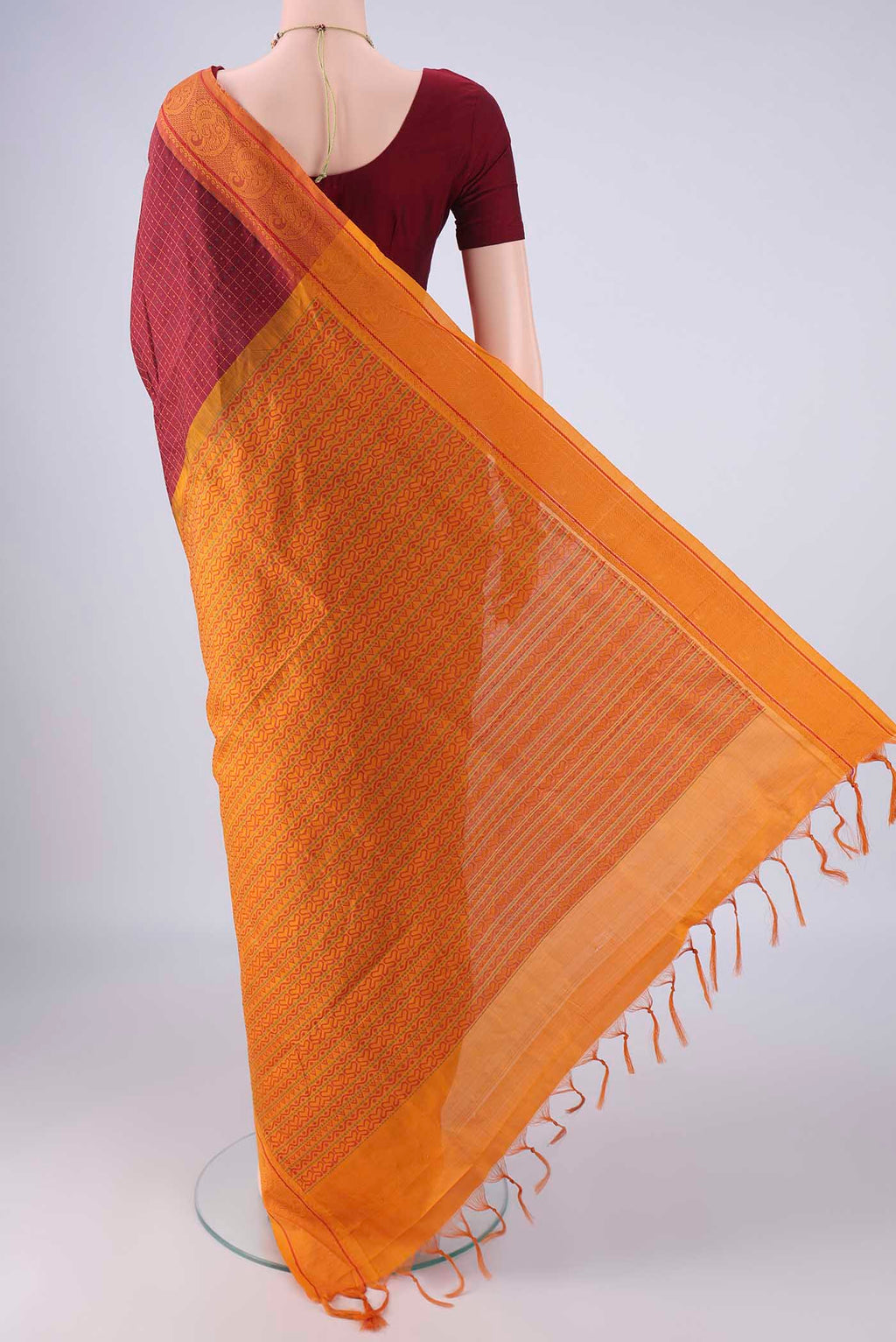 Flat view of Maroon Poly Cotton Saree with Checked design on the body and Thread Border. 