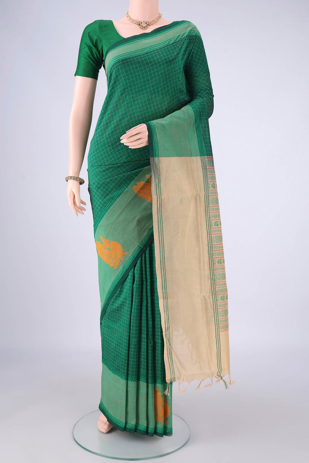 Bottle Green Blended Poly Cotton Saree with Checked design on the body and Thread Border.  displayed on a mannequin