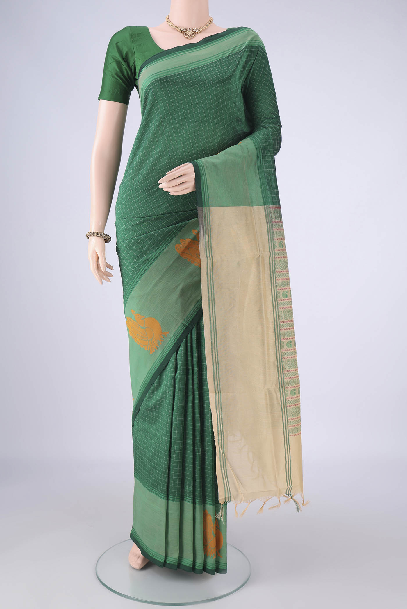 Bottle Green Blended Poly Cotton Saree with Checked design on the body and Thread Border.  displayed on a mannequin