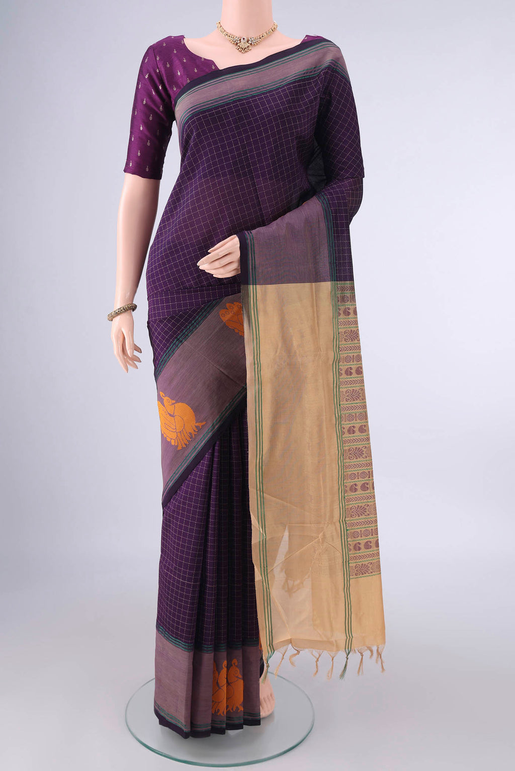 Burgundy Blended Poly Cotton Saree with Checked design on the body and Thread Border.  displayed on a mannequin