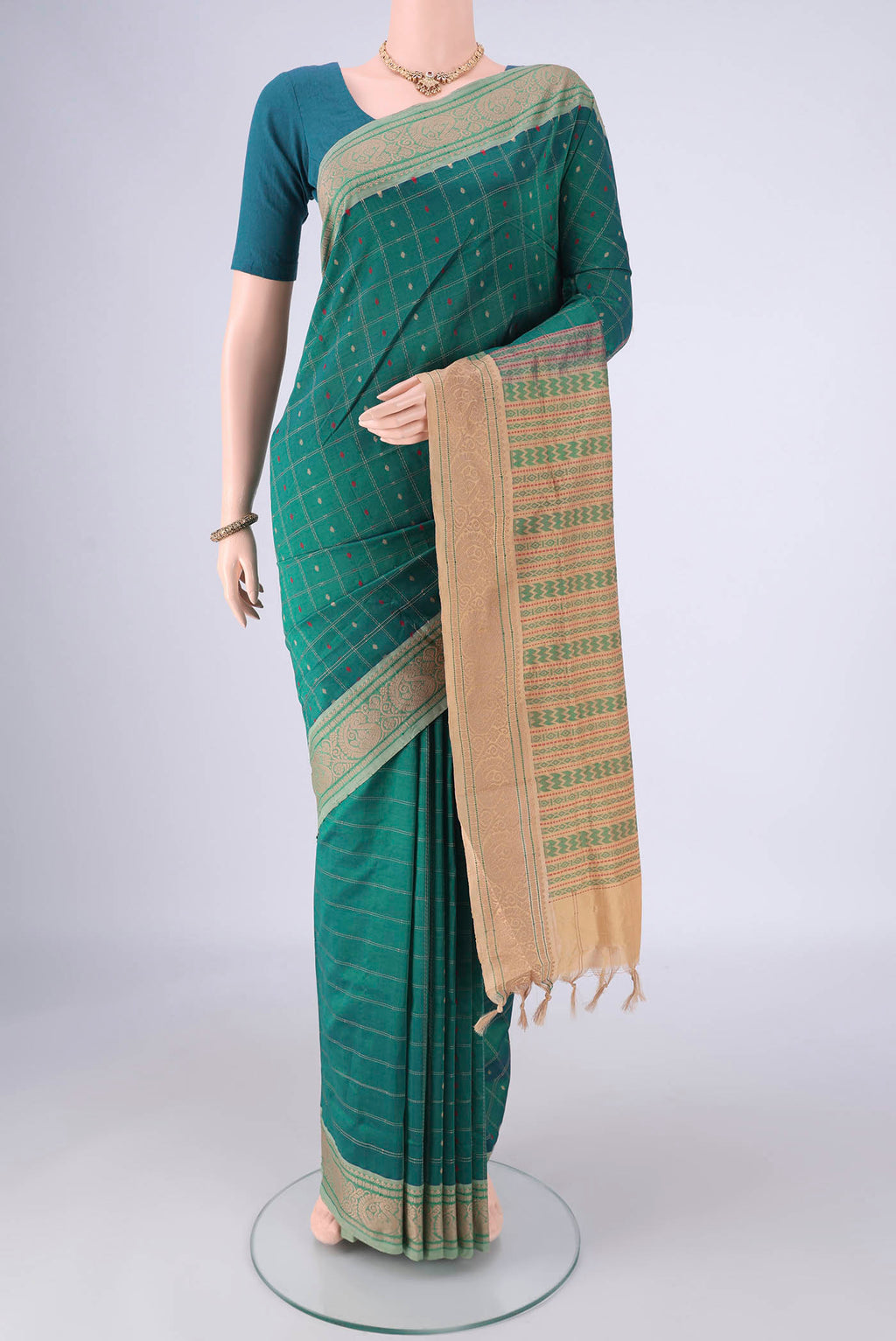 Green Blended Poly Cotton Saree with Checked design on the body and Thread Border.  displayed on a mannequin