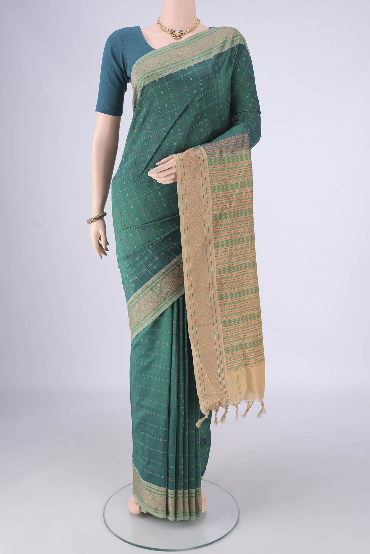 Green Blended Poly Cotton Saree with Checked design on the body and Thread Border.  displayed on a mannequin