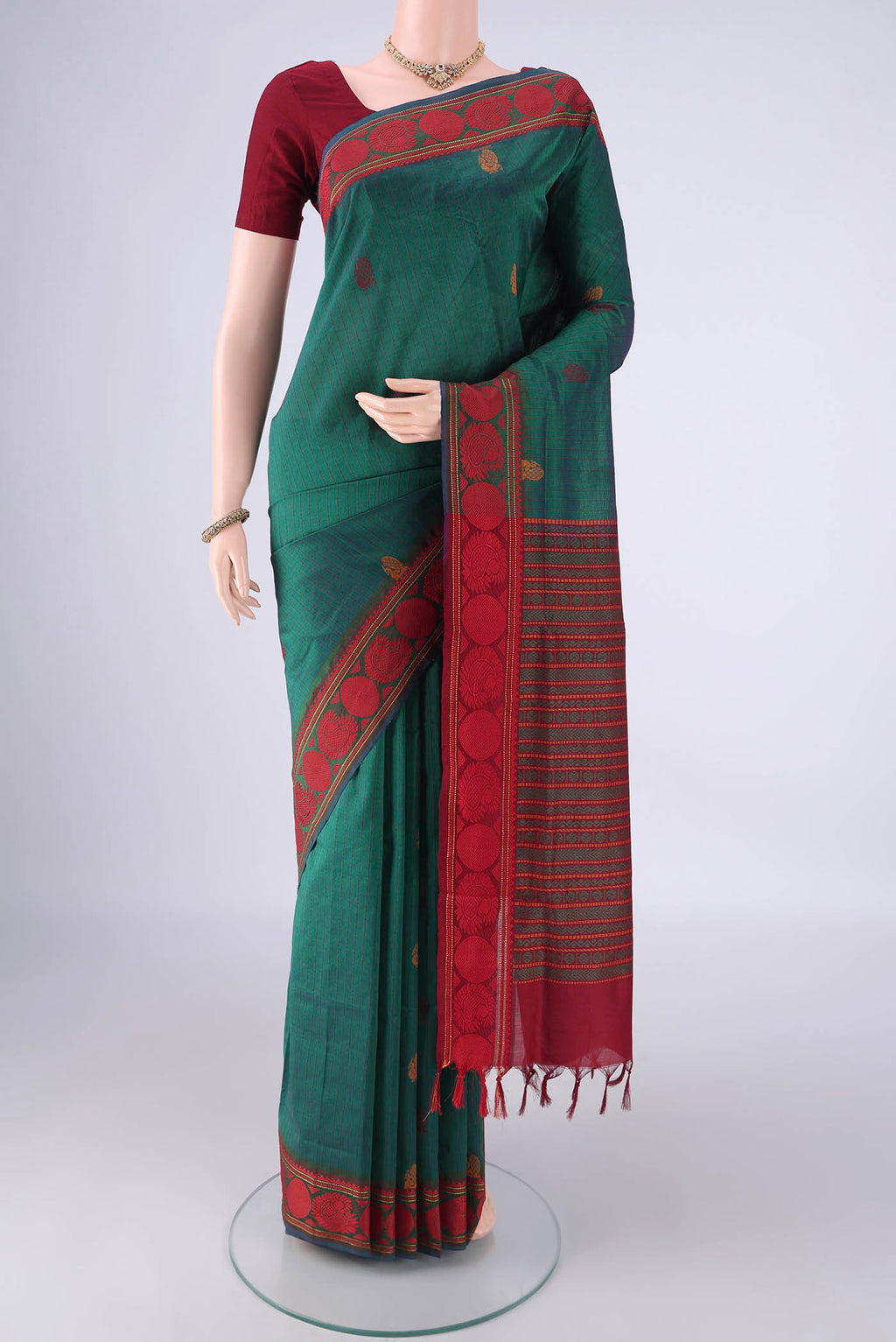 Bottle Green Poly Cotton Saree with Checked design on the body and Thread Border.  displayed on a mannequin