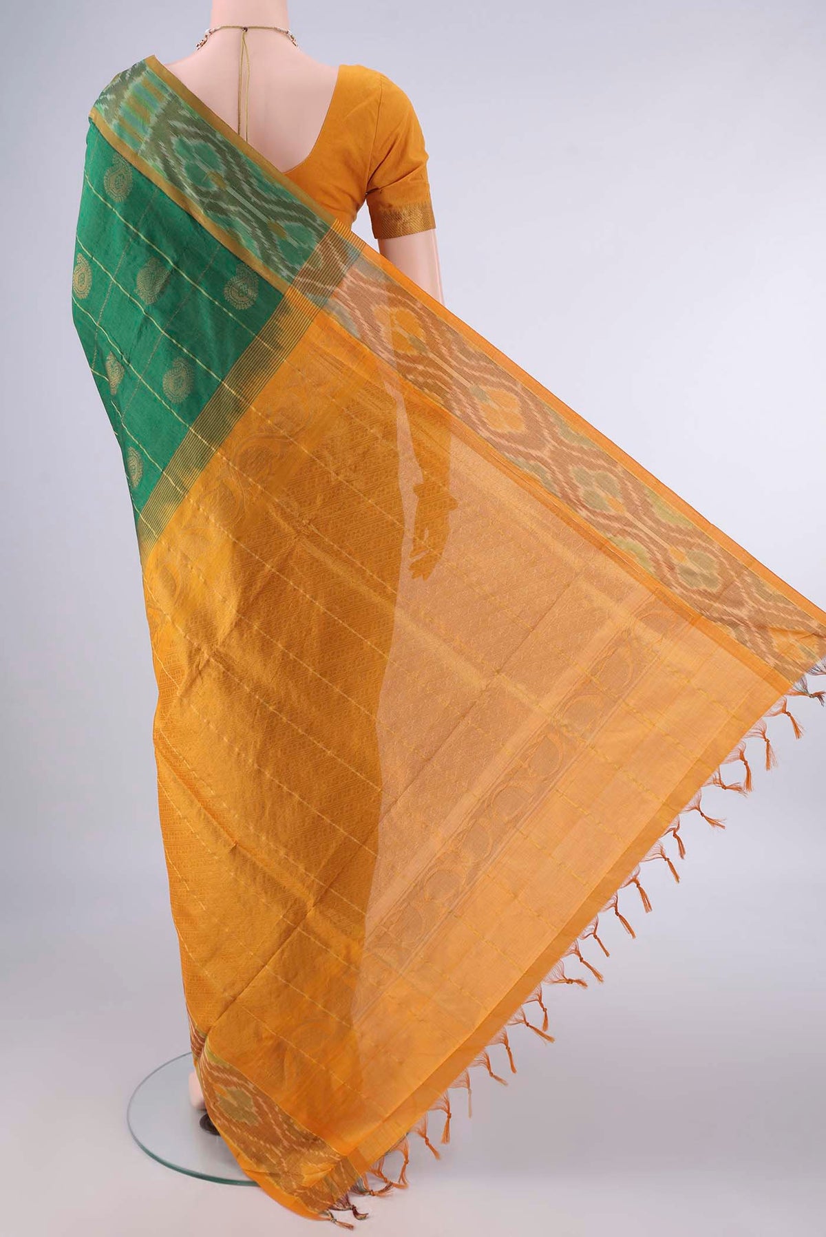 Flat view of Green Blended Poly Cotton Saree with Checked design on the body and Ikat Border. 