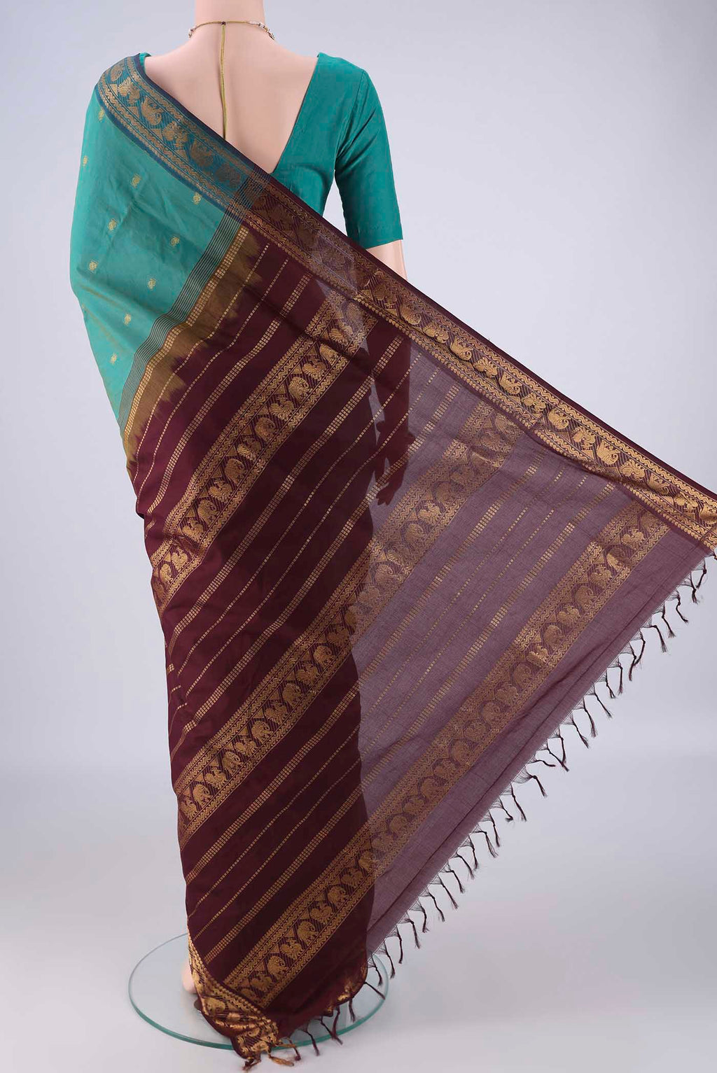 Flat view of Green Blended Poly Cotton Saree with Zari Butta on the body and Zari Border. 