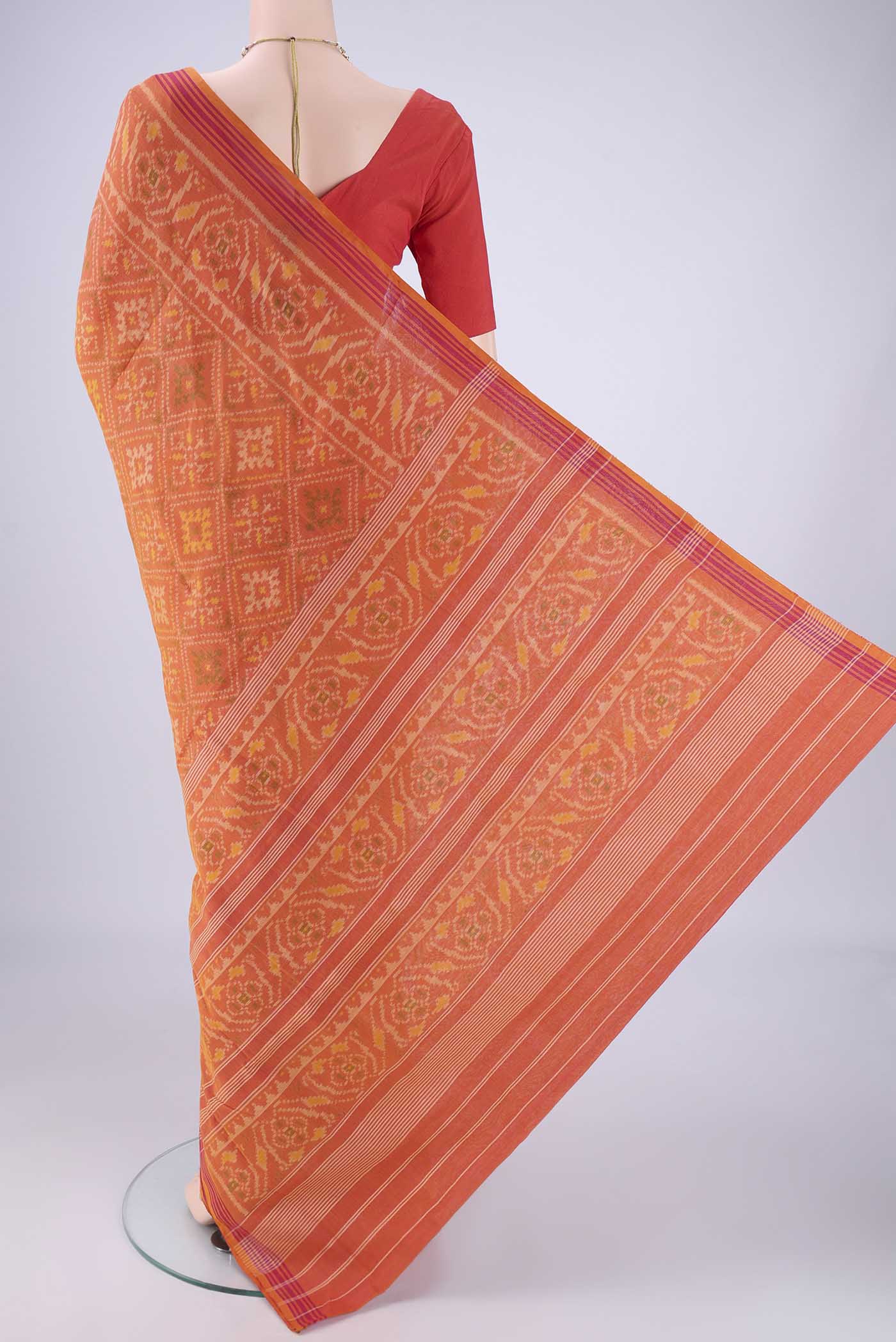 Flat view of Brick Orange Pochampally Cotton Saree with Pure Ikat on the body and Ikat Border. 