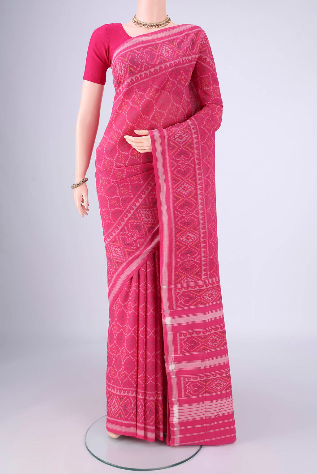 Rani Pink Pochampally Cotton Saree with Pure Ikat on the body and Ikat Border.  displayed on a mannequin