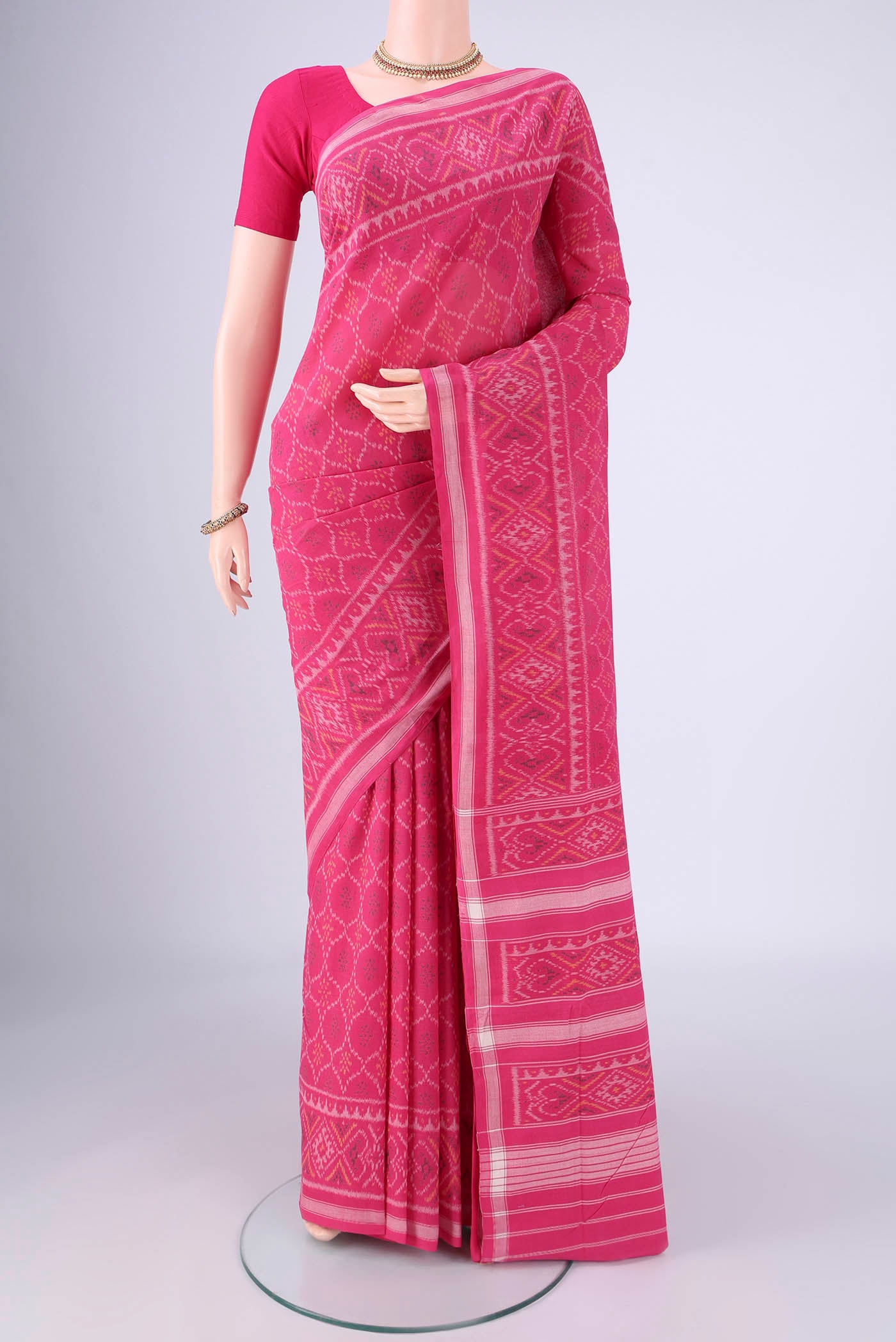 Rani Pink Pochampally Cotton Saree with Pure Ikat on the body and Ikat Border.  displayed on a mannequin