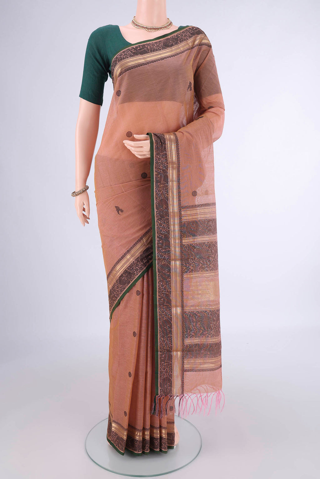 Coral Kanchi Cotton Saree with Thread Butta on the body and Zari Border.  displayed on a mannequin