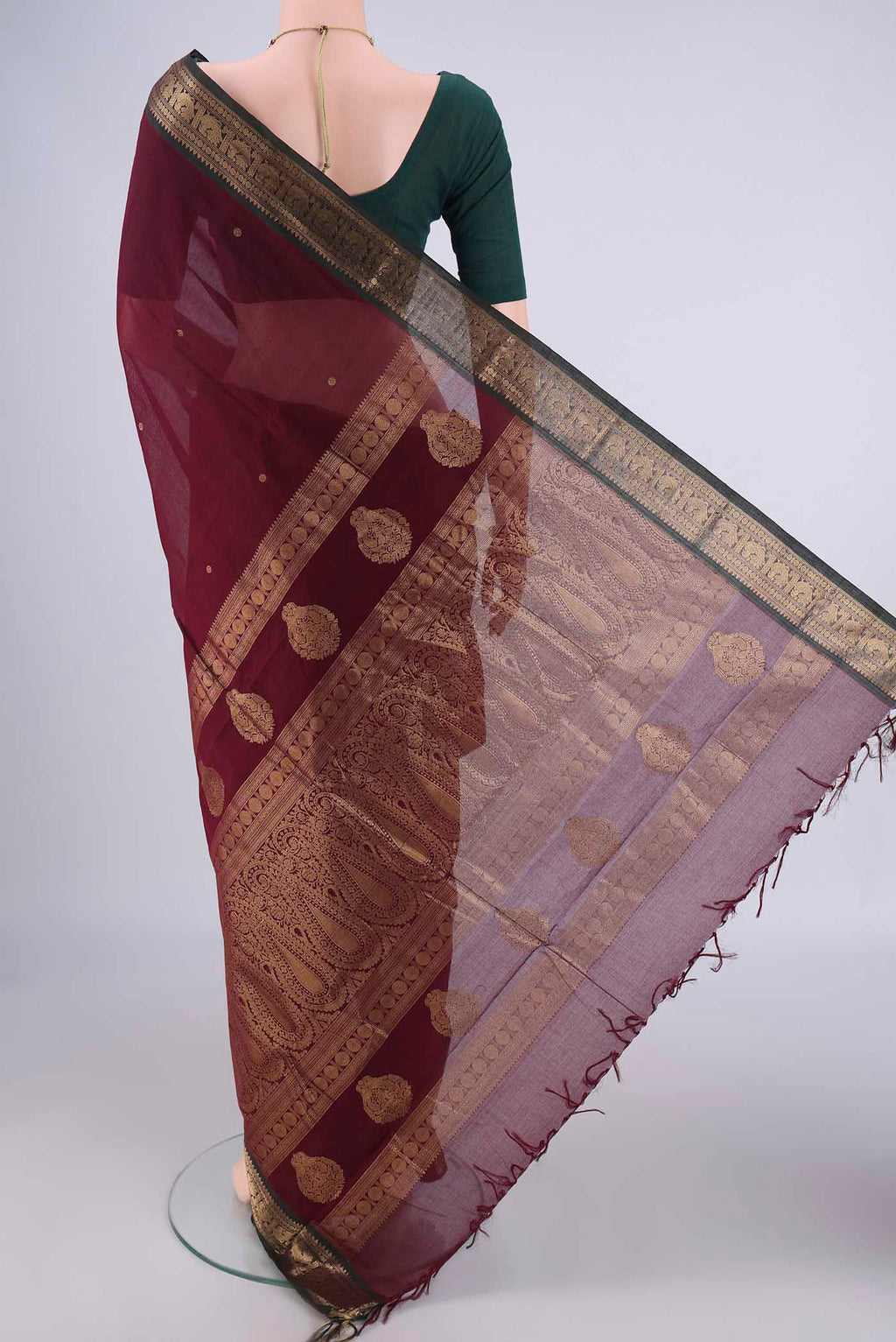 Flat view of Maroon Kanchi Cotton Saree with Zari Butta on the body and Zari Border. 
