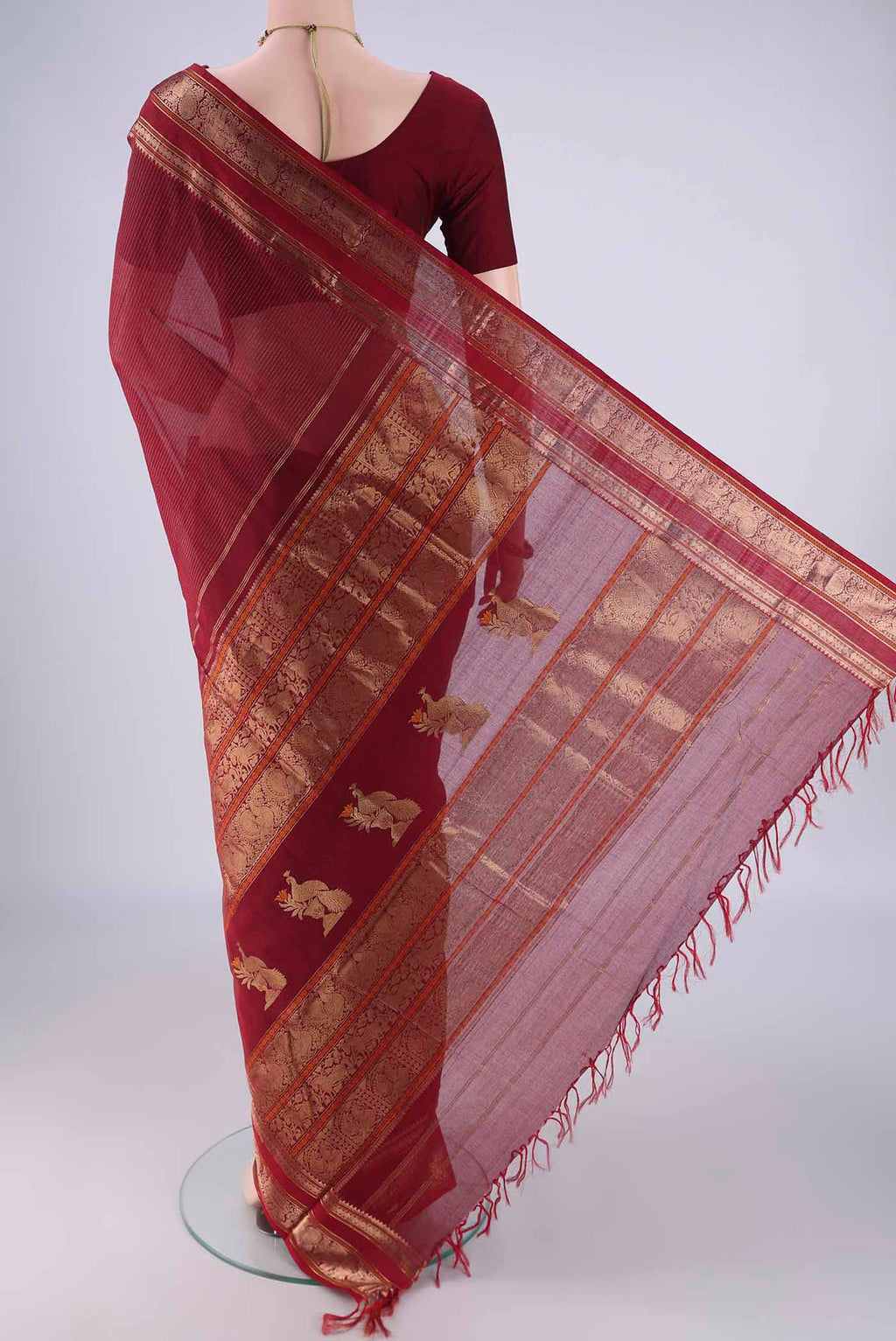 Flat view of Maroon Kanchi Cotton Saree with Stripes on the body and Zari Border. 