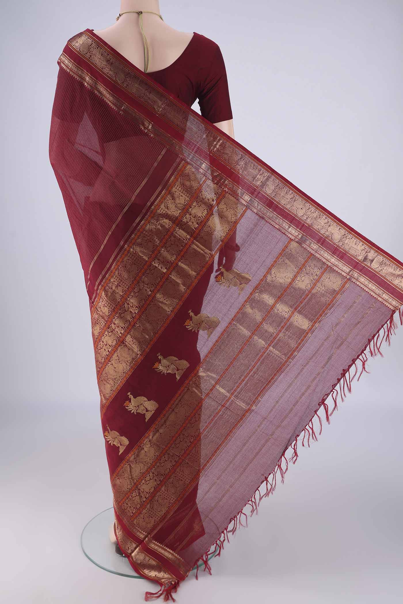 Flat view of Maroon Kanchi Cotton Saree with Stripes on the body and Zari Border. 