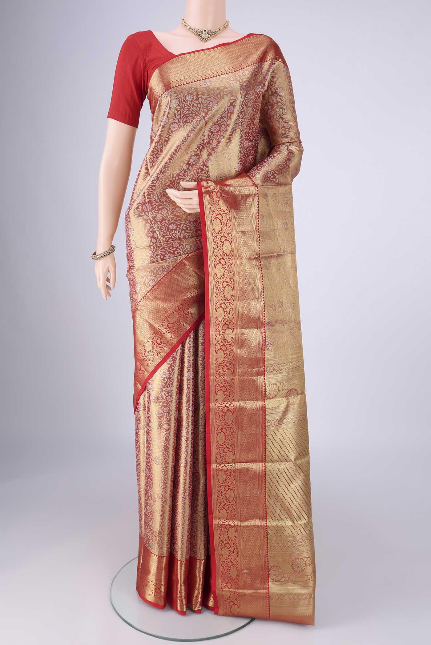 Gold with Red Dual Tone Kanjivaram Tissue Silk Saree with Zari Brocade on the body and Zari Border.  displayed on a mannequin