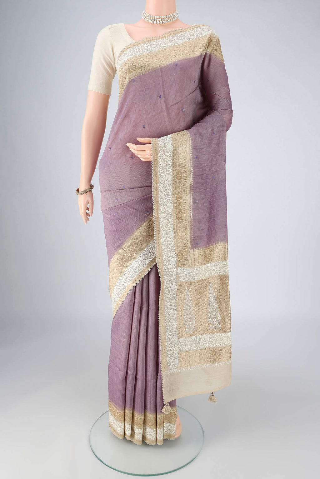 Lavender MP Tussar Saree with Embroidery on the body and Zari And Thread Border.  displayed on a mannequin