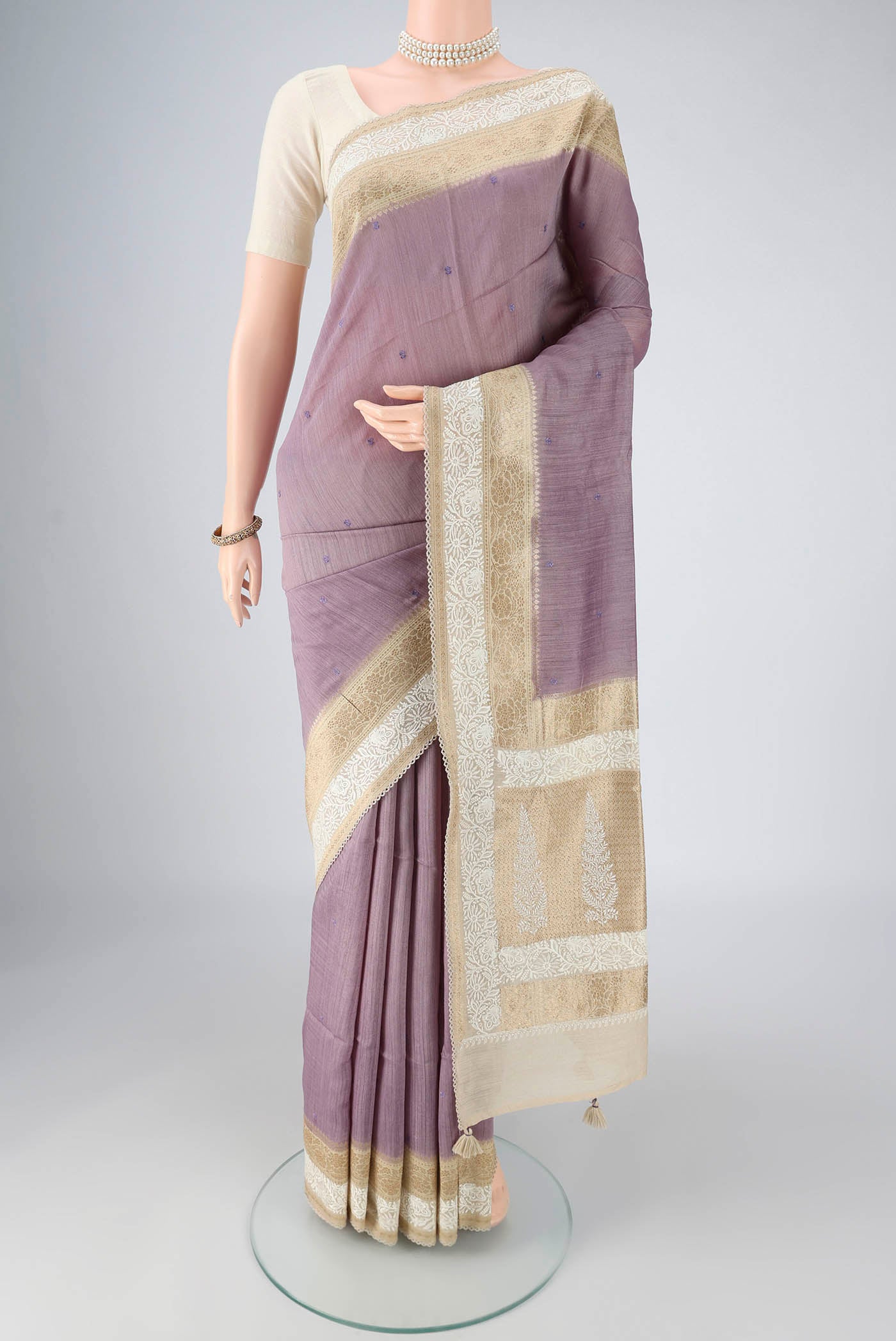 Lavender MP Tussar Saree with Embroidery on the body and Zari And Thread Border.  displayed on a mannequin