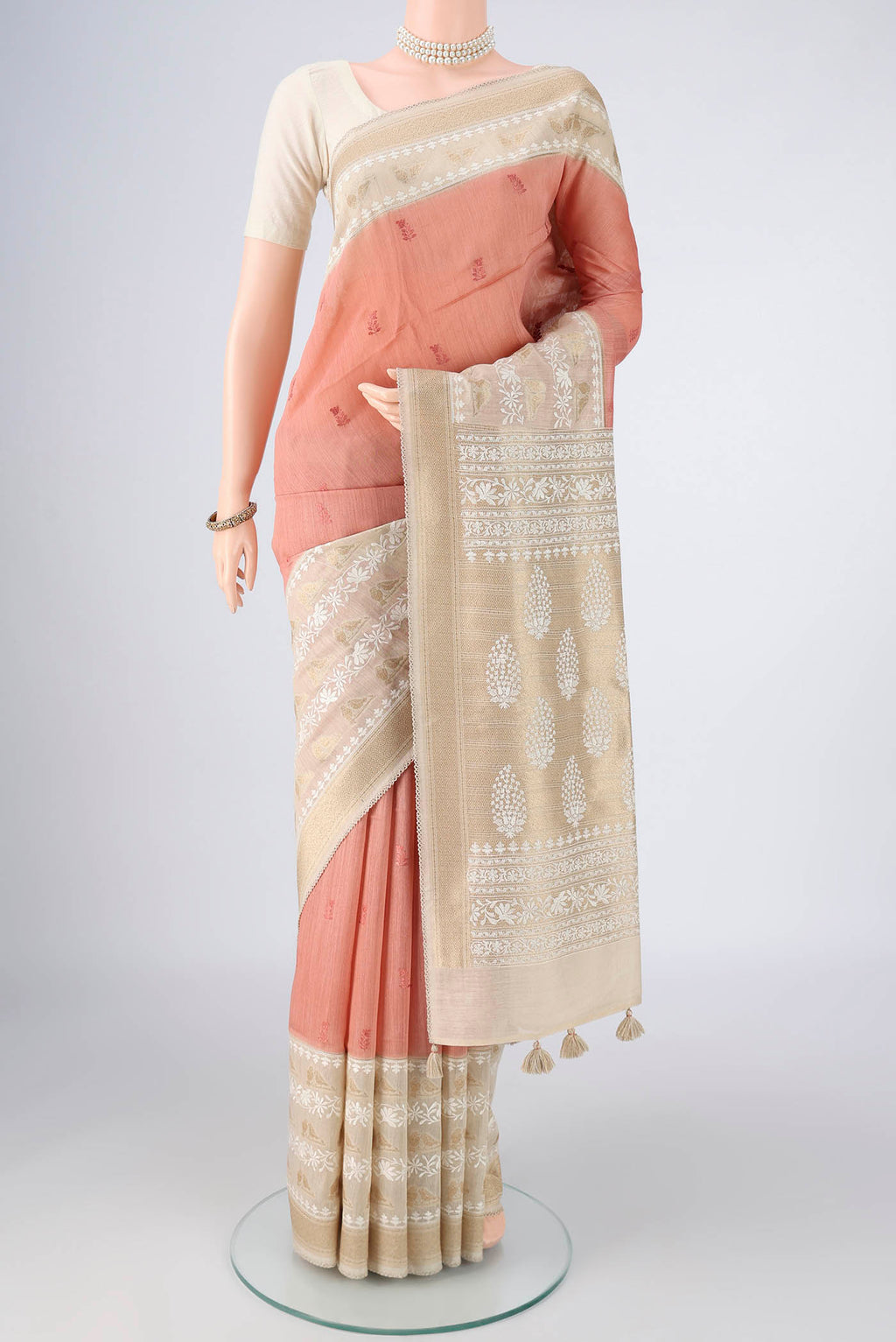 Coral MP Tussar Saree with Embroidery on the body and Zari And Thread Border.  displayed on a mannequin