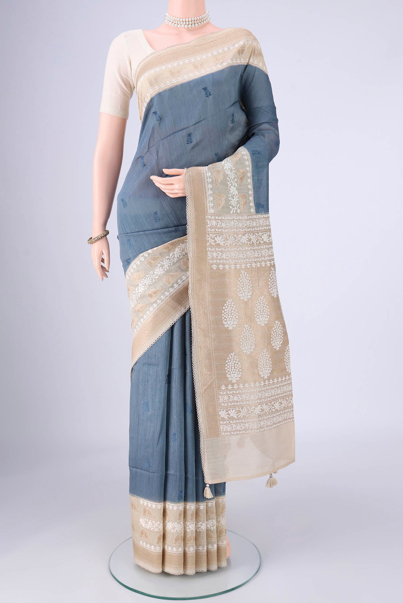 Blue Grey MP Tussar Saree with Embroidery on the body and Zari And Thread Border.  displayed on a mannequin