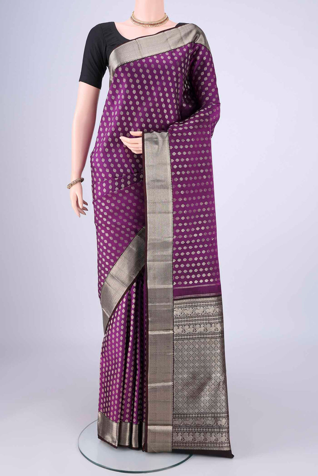 Purple Kanchipuram Silk Saree with Zari Butta on the body and Zari Border.  displayed on a mannequin