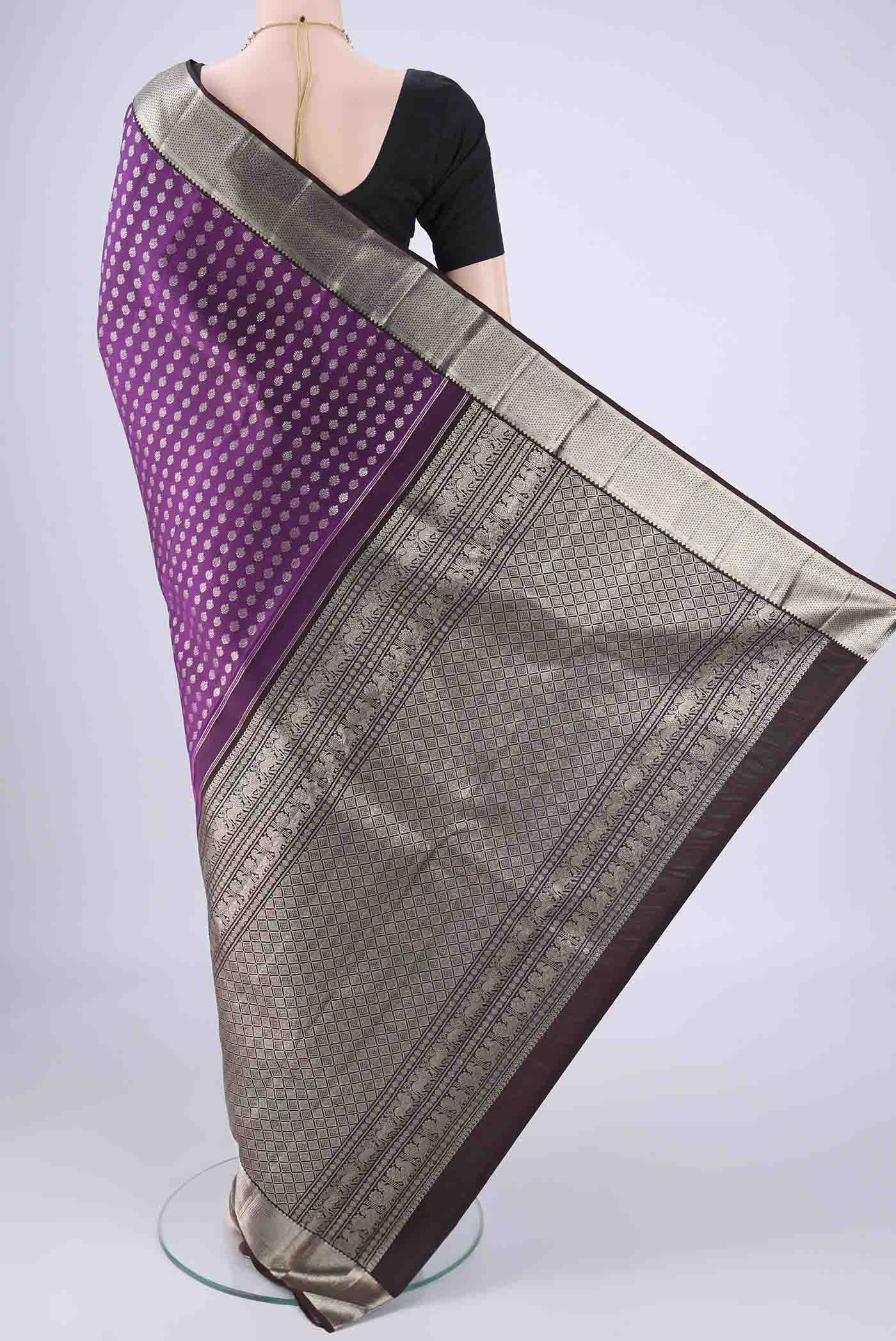 Flat view of Purple Kanchipuram Silk Saree with Zari Butta on the body and Zari Border. 