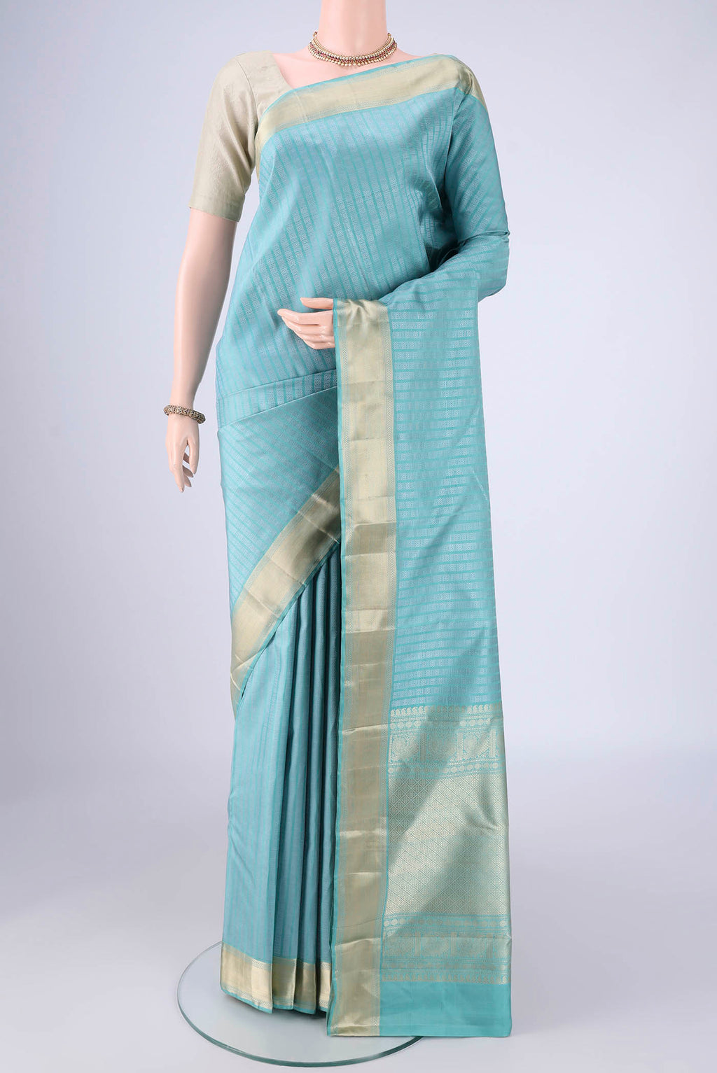 Sky Blue Kanchipuram Silk Saree with Jacquard design on the body and Zari Border.  displayed on a mannequin